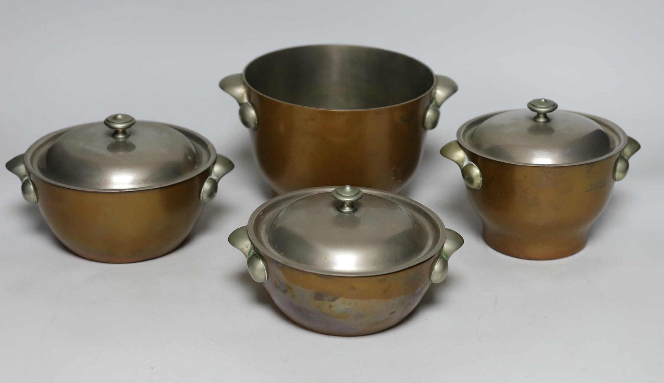 Four graduated Elkington & Co. copper bowls, three with covers, tallest 12cm